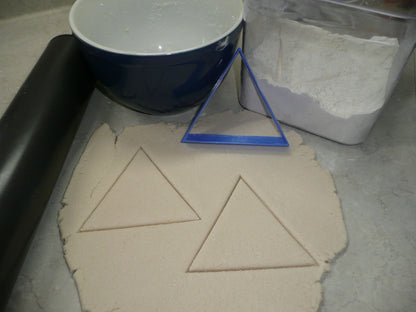 equilateral triangle cookie cutter with dough cut outs